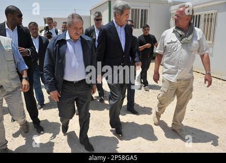 U.S. Secretary State John Kerry, center, walks with Zaatari refugee camp manager Killian Kleinschmidt, right, and Jordanian Foreign Minister Nasser Judeh, left, during a visit to Zaatari refugee camp on Thursday, July 18, 2013 near the Jordanian city of Mafraq, some 8 kilometers from the Jordanian-Syrian border. Visiting the Zaatari refugee camp in northern Jordan, Kerry met six representatives of its 115,000-strong population, all of whom appealed to him to create no-fly zones and set up humanitarian safe havens inside Syria. The Obama administration has boosted assistance to the Syrian oppos