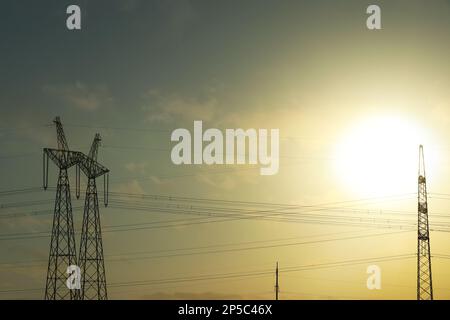 Telephone poles with cables on sunny day outdoors Stock Photo