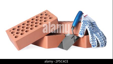 Pile of red bricks, trowel and gloves on white background Stock Photo