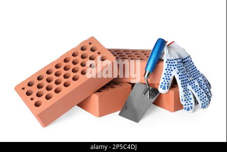 Pile of red bricks, trowel and gloves on white background Stock Photo