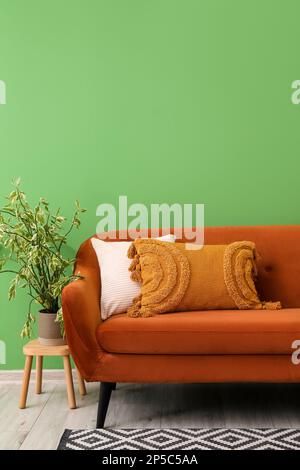 Comfy couch with pillows surrounded by houseplants Stock Photo - Alamy