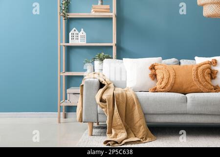 Comfy couch with pillows surrounded by houseplants Stock Photo - Alamy