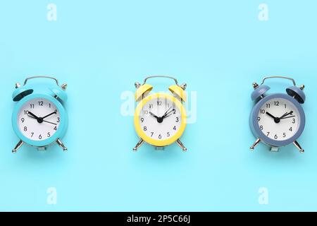 Alarm clocks on blue background Stock Photo