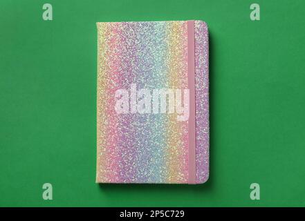 New stylish planner with hard cover on green background, top view Stock Photo
