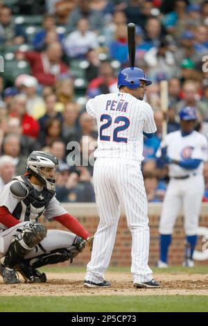 CHICAGO, IL - MAY 12: Carlos Pena #22 of the Chicago Cubs stands at first  base as a detail view of the back of his jersey can be seen against the St.