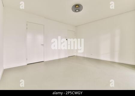 an empty room with white walls and light coming in through the window to see what is going on the wall Stock Photo