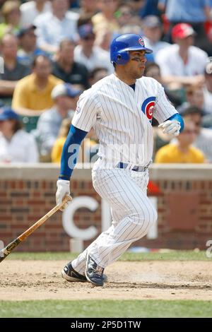 CHICAGO, IL - MAY 12: Carlos Pena #22 of the Chicago Cubs stands at first  base as a detail view of the back of his jersey can be seen against the St.