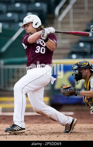 Luke Voit #30 of the Missouri State Bears follows through his swing after  making contact on a pitch during a game against the Wichita State Shockers  at Hammons Field on May 5