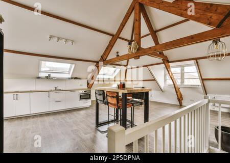 a kitchen and dining area in an attic style home with skylights on the ...