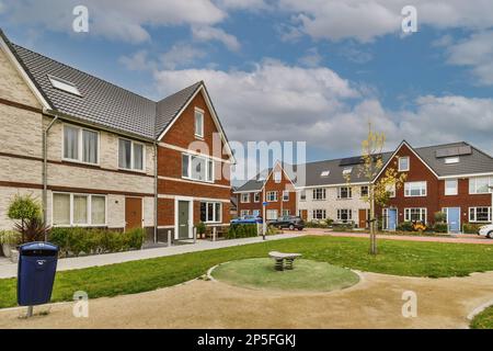 some houses that are in the same location, and one is on the other side of the house with no windows Stock Photo
