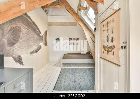 a fish hanging on the side of a wall in a room with white walls and wood flooring under it Stock Photo