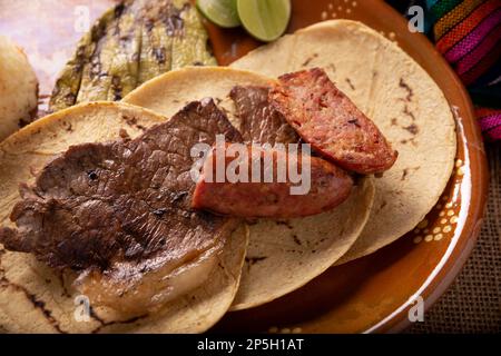 Carne Asada. (roast meat) very popular dish in northern Mexico, also called Asado, Discada or Parrillada, is a cooking technique in which food is expo Stock Photo