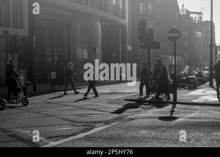 Oxford Street is a major road in the West End of London. walking people shops  and traffic early morning on road. Stock Photo