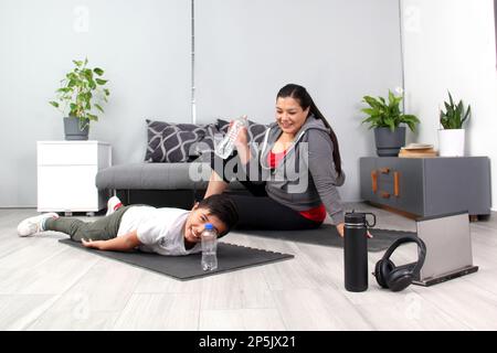 https://l450v.alamy.com/450v/2p5jx21/latino-mom-and-son-drink-water-hydrate-and-listen-to-music-after-exercising-tired-and-happy-to-do-their-physical-activity-together-2p5jx21.jpg