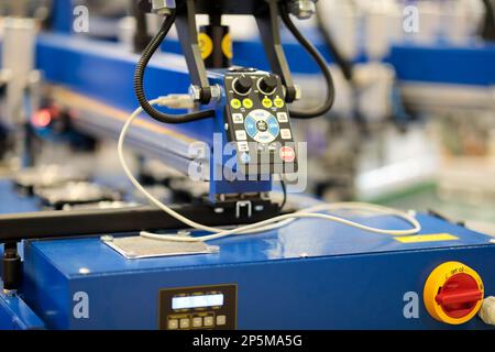 Controls of t-shirt screen printing rotary machine. Selective focus. Stock Photo