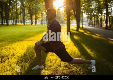 sportsman sit-ups workout outdoor exercises Stock Photo