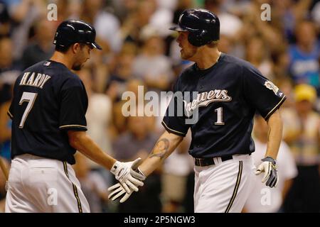 HOT START: Milwaukee's J.J. Hardy is congratulated by teammate Corey Hart  after scoring the game winning