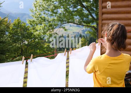 Colorful laundry hanging on rope in summer garden in typical