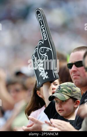 A young fan holds up a foam finger and a Pirate Parrot plush toy during the  Pittsburgh Pirates' home-opener baseball game against the Chicago Cubs on  Tuesday, April 12, 2022, in Pittsburgh. (