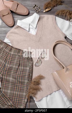 Fall fashion. Layout with women's outfit on wooden background, top view Stock Photo