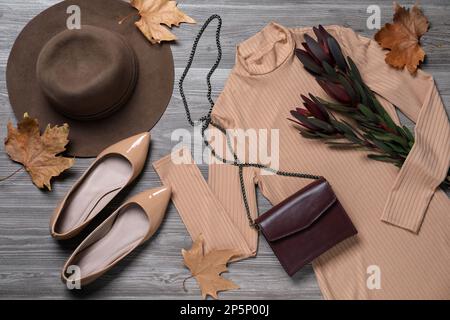 Fall fashion. Layout of women's outfit on wooden background, top view Stock Photo