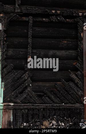 Completely burned black wooden house Stock Photo