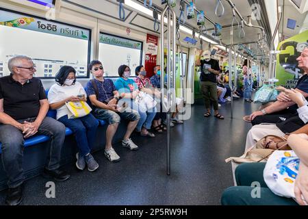 Foreign and Thai passengers traveling on BTS Skytrain elevated railway, Bangkok, Thailand Stock Photo