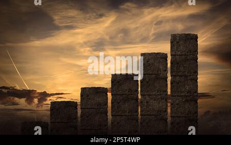 Business Graph Made By Rock Blocks Build with stairs at sunset. Growth and hard work, development and building an empire Stock Photo