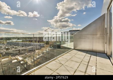 a city from the top of a building with clouds in the sky and sun shining through the window panoray Stock Photo