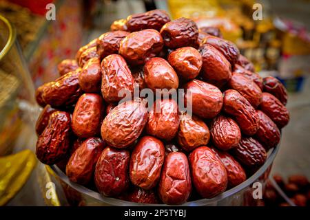 In the Xinjiang Grand Bazaar, a cup full of huge red dates and dried fruits Stock Photo