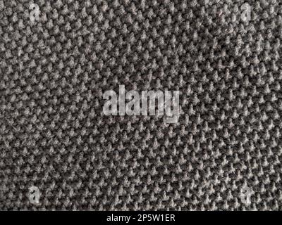 Gray knitted texture of woolen fabric close-up. Textile knit pattern wallpaper abstract background surface for design. Handmade shops matte soft cozy Stock Photo