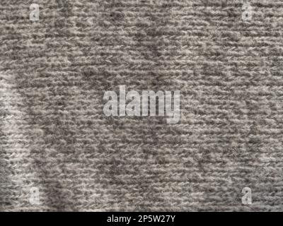 Gray knitted texture of woolen fabric close-up. Textile knit pattern wallpaper abstract background surface for design. Handmade shops matte soft cozy Stock Photo