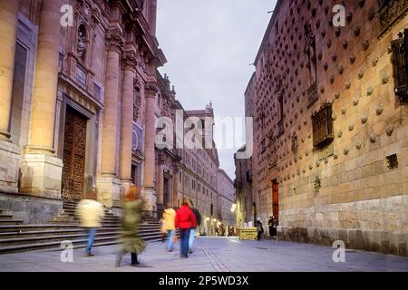 At right Casa de las Conchas, at left La Clerecía,Compañía street,Salamanca,Spain Stock Photo