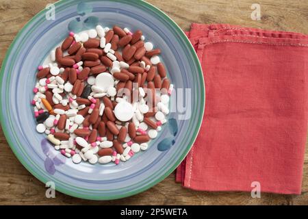wellness and food concept with a plate full of medicines Stock Photo