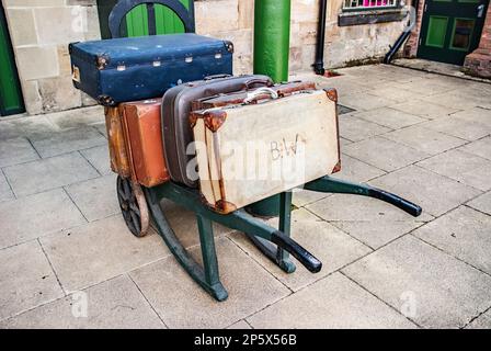 Old luggage cars and suitcases at Pickering Station, a must-see 1930’s themed station that will transport you back in time to the steam era. Stock Photo