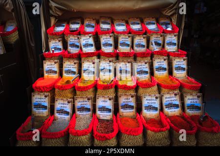 Baskets of loose spices on market stall in Granada Spain Stock Photo