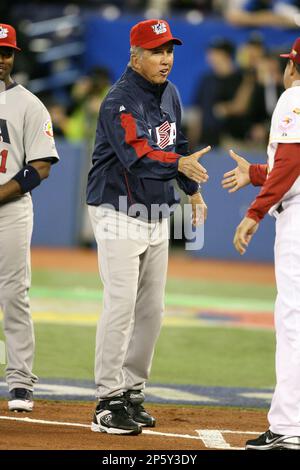 Team USA manager Davey Johnson (R) chats with Derek Jeter between innings  during their game against Team Venezuela in Round 1 of the World Baseball  Classic at the Rogers Center in Toronto