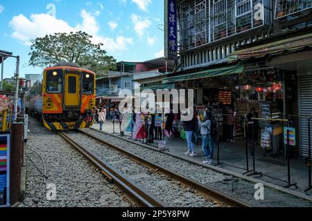 Shifen, Taiwan - February 17, 2023: Tourists taking photos of a train in Shifen in Pingxi District, Taiwan. Stock Photo