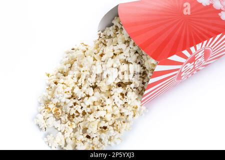 Popcorn in red and white striped cardboard bucket isolated on white background Stock Photo