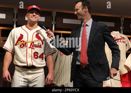 St. Louis Cardinals President Bill DeWitt III (R) points out the highlights  of the team's new uniform on pitcher Trevor Rosenthal at Busch Stadium in St.  Louis on November 16, 2012. For