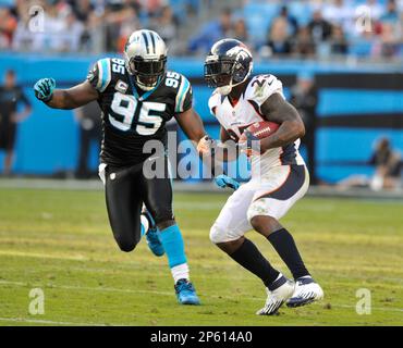 Denver Broncos running back Willis McGahee (L) scores against Buffalo Bills  linebacker Reggie Torbor on a 13-yard touchdown pass in the second quarter  at Sports Authority Field at Mile High in Denver