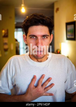 Young male having heart attack at home Stock Photo