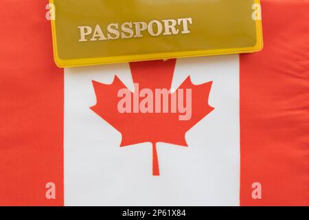 Flag of canada with passport. Travel visa and citizenship concept. residence permit in the country. a yellow document with the inscription passport is Stock Photo