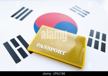 South Korean passport,Republic of Korea passport on the top of an satin korean flag Stock Photo