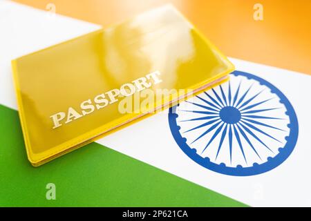 Flag of India with passport. Travel visa and citizenship concept. residence permit in the country. a yellow document with the inscription passport is Stock Photo