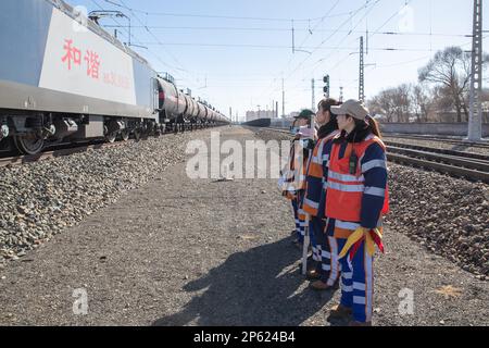 (230307) -- HARBIN, March 7, 2023 (Xinhua) -- Inspectors work at the Dorbod Railway Station in Daqing, northeast China's Heilongjiang Province, March 6, 2023. At the Dorbod railway line maintenance section of China Railway Harbin Bureau Group Co., Ltd., there is a six-member team of female inspectors with an average age of 29. Their responsibilities include maintaining the railway lines for grain and oil transport, as well as 148 kilometers of Binzhou railway line, which is a crucial part of China-Europe rail transport service line. Despite facing challenging conditions, they tackle daily main Stock Photo