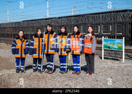 (230307) -- HARBIN, March 7, 2023 (Xinhua) -- Female inspectors pose for a group photo along the railway in Daqing, northeast China's Heilongjiang Province, March 6, 2023. At the Dorbod railway line maintenance section of China Railway Harbin Bureau Group Co., Ltd., there is a six-member team of female inspectors with an average age of 29. Their responsibilities include maintaining the railway lines for grain and oil transport, as well as 148 kilometers of Binzhou railway line, which is a crucial part of China-Europe rail transport service line. Despite facing challenging conditions, they tack Stock Photo