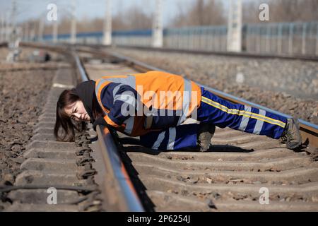 (230307) -- HARBIN, March 7, 2023 (Xinhua) -- Inspector Cao Yan checks the tracks at the Dorbod Railway Station in Daqing, northeast China's Heilongjiang Province, March 6, 2023. At the Dorbod railway line maintenance section of China Railway Harbin Bureau Group Co., Ltd., there is a six-member team of female inspectors with an average age of 29. Their responsibilities include maintaining the railway lines for grain and oil transport, as well as 148 kilometers of Binzhou railway line, which is a crucial part of China-Europe rail transport service line. Despite facing challenging conditions, th Stock Photo