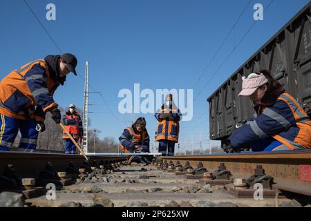 (230307) -- HARBIN, March 7, 2023 (Xinhua) -- Female inspectors work at the Dorbod Railway Station in Daqing, northeast China's Heilongjiang Province, March 6, 2023. At the Dorbod railway line maintenance section of China Railway Harbin Bureau Group Co., Ltd., there is a six-member team of female inspectors with an average age of 29. Their responsibilities include maintaining the railway lines for grain and oil transport, as well as 148 kilometers of Binzhou railway line, which is a crucial part of China-Europe rail transport service line. Despite facing challenging conditions, they tackle dai Stock Photo