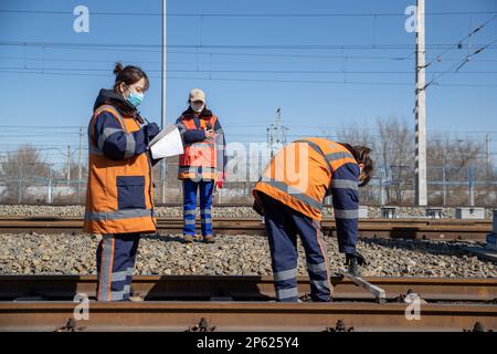 (230307) -- HARBIN, March 7, 2023 (Xinhua) -- Female inspectors work at the Dorbod Railway Station in Daqing, northeast China's Heilongjiang Province, March 6, 2023. At the Dorbod railway line maintenance section of China Railway Harbin Bureau Group Co., Ltd., there is a six-member team of female inspectors with an average age of 29. Their responsibilities include maintaining the railway lines for grain and oil transport, as well as 148 kilometers of Binzhou railway line, which is a crucial part of China-Europe rail transport service line. Despite facing challenging conditions, they tackle dai Stock Photo